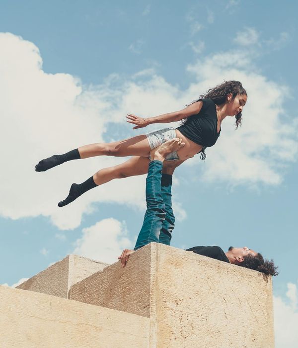 Man performing a controlled strength exercise in a minimalist space.
